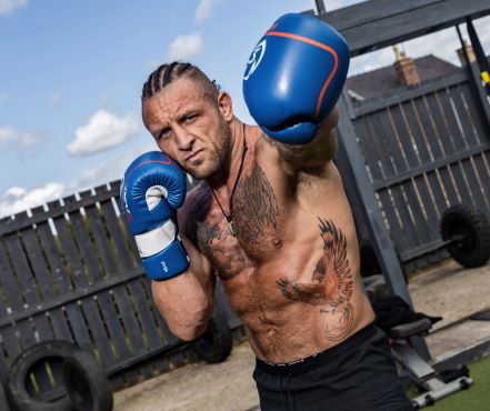 Boditronics Athlete Anthony Holmes in boxing pose in outside gym area