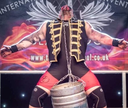 Boditronics' Ambassador and Strong Man Steve Titan lifting a Beer Keg with his head in feat of strength